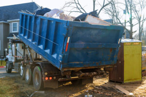 Removal of debris construction waste building demolition with rock and concrete rubble on portable bio-toilets